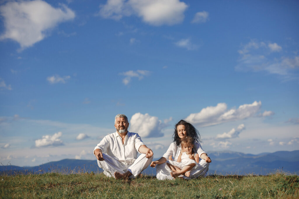 People in a mountain. Grandparents with grandchildren. Woman in a white dress.