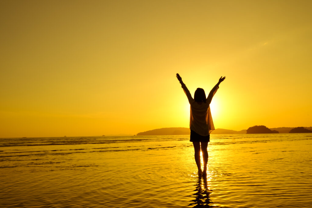 Relax Woman jumping sea on the beach   Sunset silhouette,Happy Vacation Holiday Concept.